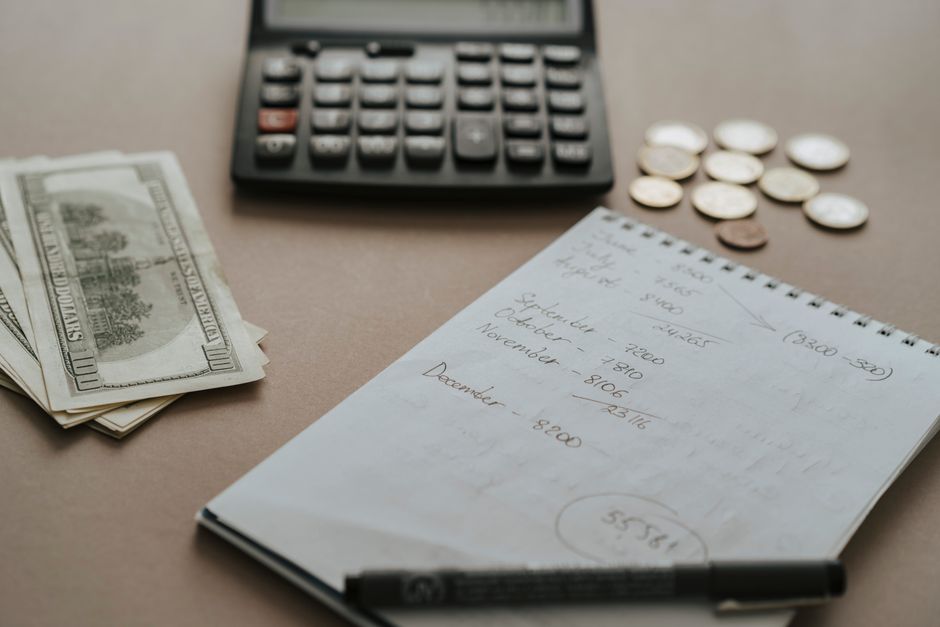 Open notebook and a coffee cup on a table, ready for a thoughtful household money check-in